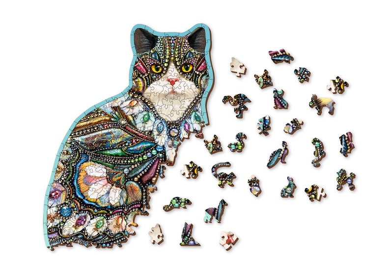 May include: A wooden jigsaw puzzle of a cat with a colorful mosaic design. The puzzle is partially assembled, with some pieces scattered around the cat.