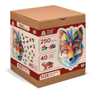 May include: A cardboard box containing a 250 piece wooden jigsaw puzzle featuring a fox wearing a colourful headdress. The puzzle measures 356 x 254 mm and has 40 unique whimsical shapes.