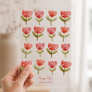 Könnte beinhalten: Ein durchsichtiges rechteckiges Blatt mit einem Raster aus sechzehn aquarellartigen roten Tulpen mit grünen Stielen und Blättern. Jede Tulpe hat ein einfaches lächelndes Gesicht mit rosa Wangen. Der Text "Happy Tulips" und "www.bearnature.de" ist unten aufgedruckt.