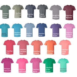 May include: A collection of 20 t-shirts in various heather colours, including forest green, military green, navy, dark heather, graphite heather, maroon, Galapagos, sapphire, indigo, royal, purple, radiant orchid, red, cardinal red, bronze, orange, coral silk, antique heliconia, heliconia, berry, Irish green, and seafoam.