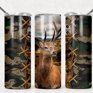 May include: A stainless steel tumbler with a camouflage pattern and a brown deer head design. The tumbler has a brown rope design on the side.