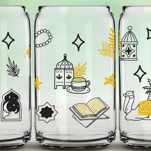 May include: Three clear glass tumblers with black and yellow illustrations of Islamic symbols, including a crescent moon, a mosque, a lantern, a palm tree, a prayer rug, a book, a cup of tea, and a camel.
