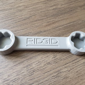 May include: A gray RIDGID wrench with two 6-point sockets on either end.