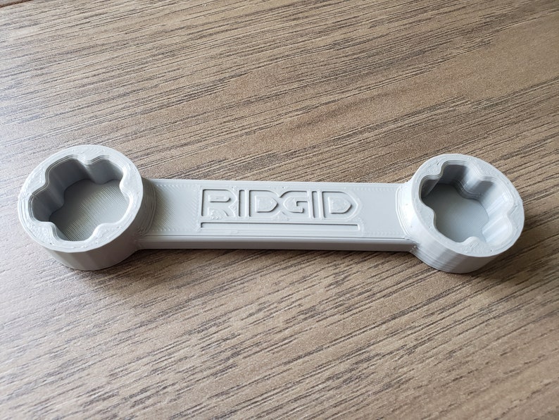 May include: A gray RIDGID wrench with two 6-point sockets on either end.
