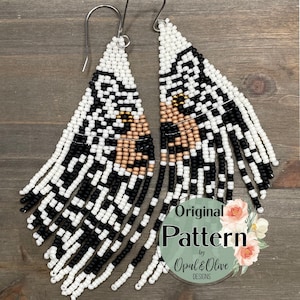 May include: Handmade beaded earrings in a triangular shape, featuring a black and white geometric pattern with fringe. The earrings have a tan and gold accent color. The text "Original Pattern by Opal & Olive Designs" is visible.