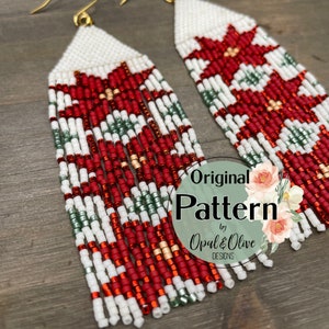 May include: A pair of long, beaded earrings with a red, white, and green geometric pattern. The earrings are made with small, round beads and have a gold hook closure. The earrings are labeled "Original Pattern by Opal & Olive Designs."