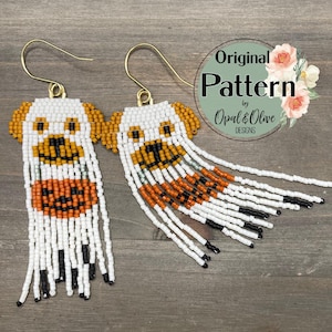 May include: A pair of beaded earrings with a ghost design. The ghost is white with orange and black details. The earrings are made with seed beads and have a fringe.