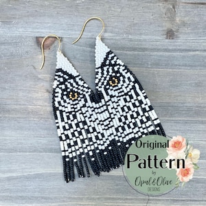 May include: Black and white beaded earrings with a geometric pattern and gold accents. The earrings are long and dangle, with a fringe at the bottom. The earrings are labelled "Original Pattern by Opal & Olive Designs".