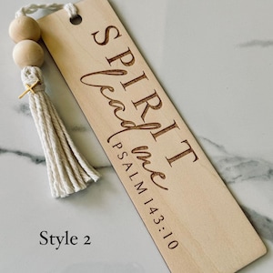 May include: Wooden bookmark with a white tassel and wooden beads. The bookmark has the text "SPIRIT lead me PSALM 143:10" engraved on it. Style 2.