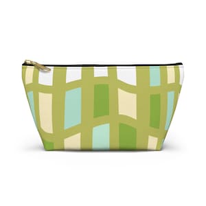 May include: A trapezoidal zippered pouch featuring a repeating pattern of wavy olive green lines intersecting to form rectangular shapes in shades of white, pale yellow, and light turquoise. The accessory includes a gold-toned metal zipper pull.