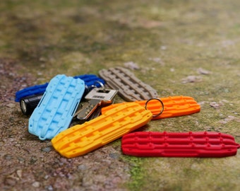 Keychain - Plastic, Pocket Size, resembles offroad recovery board.