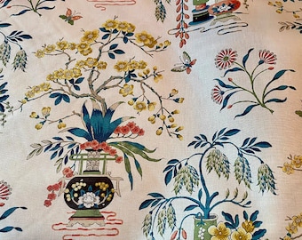 May include: Cream-colored fabric with a repeating pattern of stylized floral arrangements, butterflies, and branches. The design features vases, flowers, and foliage in shades of blue, yellow, red, and green.