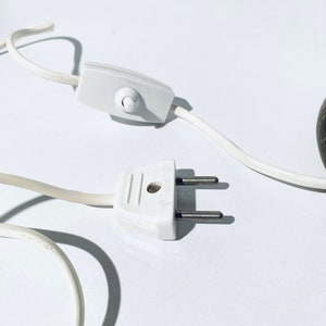 May include: White electrical cord with a white inline switch and a white two-prong plug.