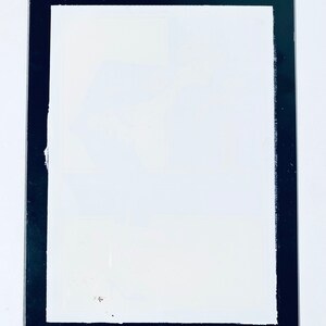 May include: A white rectangular frame with a thick black border.