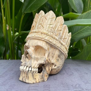 Human Skull Wood Carving with War Bonnet made from Marlin