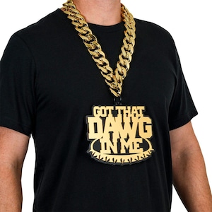 May include: A gold chain necklace with a large pendant that says "Got That Dawg In Me".