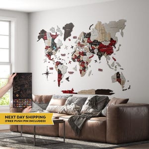 May include: A large wooden world map wall art installation featuring a multi-colored palette of natural wood, dark brown, and deep red tones. The map includes labeled continents, countries, and oceans, accented by decorative wooden airplane and boat icons.