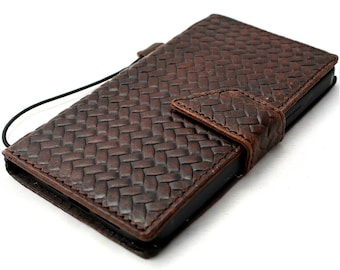 May include: A brown leather phone case with a woven pattern and a flap closure.