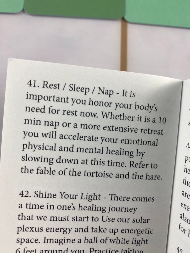 Puede incluir: Libro abierto con texto sobre descanso, sue&ntilde;o y siestas, enfatizando la importancia de honrar la necesidad de descanso del cuerpo. El texto tambi&eacute;n menciona la curaci&oacute;n emocional, f&iacute;sica y mental.
