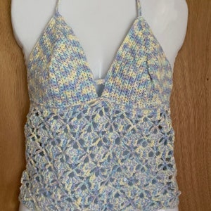 Sweet and pretty pastel crochet top with adjustable halter and corset back. Comes with FREE gift