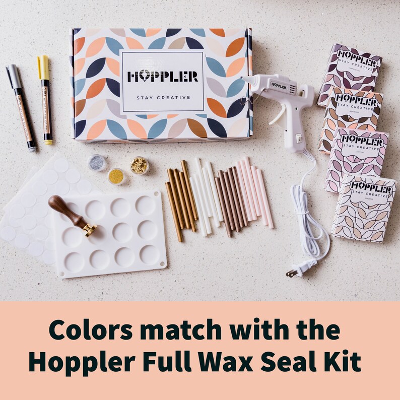 May include: A Hoppler Full Wax Seal Kit with a white glue gun, wax sticks in gold, white, brown, and pink, a silicone mold with 12 circles, a stamp, and a box with the text "Hoppler Stay Creative".