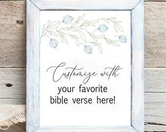 May include: A white rectangular print in a distressed light blue wooden frame. The print features a delicate line drawing of blue flowers and green leaves at the top, with the black text: Customize with your favorite bible verse here!