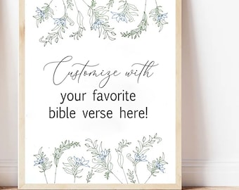 May include: A rectangular print in a light wood frame featuring black text that reads "Customize with your favorite bible verse here!" surrounded by delicate line art illustrations of green leaves and small blue flowers at the top and bottom.