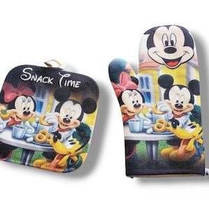 May include: A black and white oven mitt and pot holder set featuring Mickey Mouse, Minnie Mouse, and Pluto. The set has a colorful design with the words "SNACK TIME" on the pot holder. The oven mitt and pot holder are designed for kitchen use.