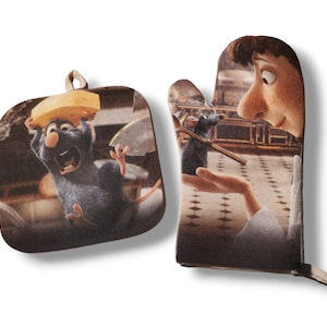 May include: A matching oven mitt and pot holder set featuring characters from the animated film, "Ratatouille." The pot holder shows a rat with cheese, while the oven mitt depicts a rat with a chef. Both items have a light brown background.
