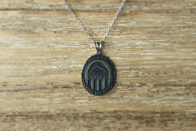 May include: Silver chain necklace with a round pendant featuring the Longwood College logo. The pendant is engraved with "Longwood College" and "Founded 1839 Virginia".