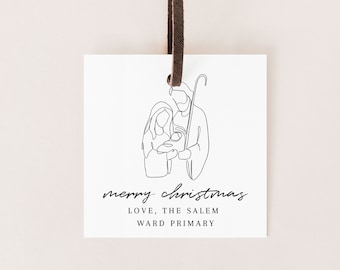 Könnte beinhalten: Ein weißer Geschenkanhänger mit einer schwarzen Linienzeichnung der Heiligen Familie. Der Text "merry christmas" ist in Kursivschrift geschrieben. Unter der Zeichnung steht der Text "LOVE, THE SALEM WARD PRIMARY."