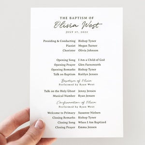 May include: A black and white programme for the baptism of Olivia West, held on 17 July 2022. The programme lists the order of events, including the opening song, prayer, remarks, baptism, and closing prayer.
