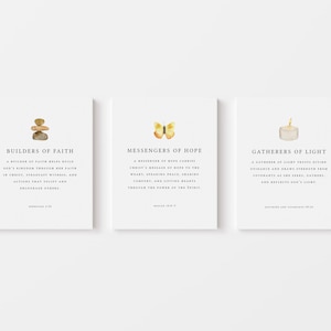 May include: Three square art prints with watercolor illustrations and text. The prints feature a stack of stones, a butterfly, and a candle. The text includes the phrases "Builders of Faith", "Messengers of Hope", and "Gatherers of Light".
