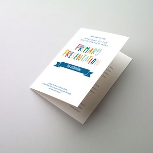 May include: A white program for a Primary Presentation at the Mountainview Ward on November 14, 2021. The program features a colorful title with the words "Primary Presentation" and a blue ribbon with the text "The Restoration".