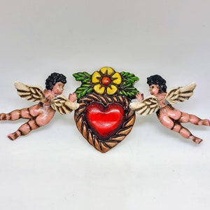 Corazón de hojalata con dos querubines