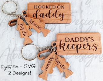 May include: Two wooden keychains with a fishing theme. The first keychain has a rectangular tag with the text "HOOKED ON daddy" and two fish charms with the names "Mason" and "Jayda". The second keychain has a rectangular tag with the text "DADDY'S keepers" and two fish charms with the names "Mason" and "Jayda".