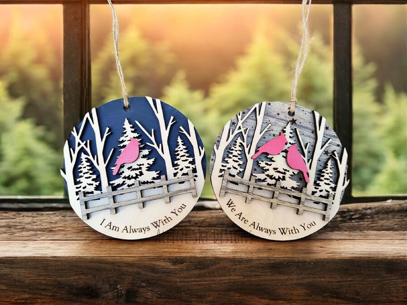 Puede incluir: Dos adornos navide&ntilde;os de madera con una escena de invierno y p&aacute;jaros rosas. Un adorno dice "I Am Always With You" y el otro dice "We Are Always With You".