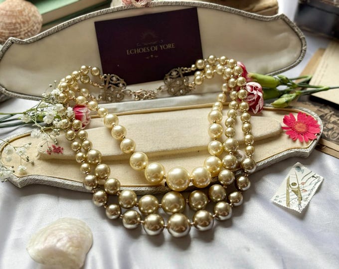 Golden graduated faux champagne pearl necklace with decorative clasp