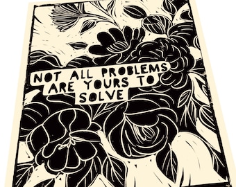 May include: Black and white print of stylized flowers with the text "Not all problems are yours to solve" in a banner.