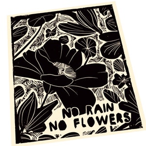 May include: Black and white linocut print of a flower with the text "No rain no flowers" in a bold, stylised font.