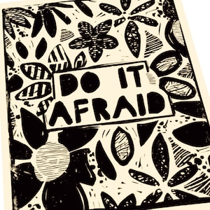 May include: Black and white floral art print with the words "DO IT AFRAID" in a rectangular box. The print features a variety of stylized flowers and leaf shapes, creating a bold and graphic design on a cream-colored background.