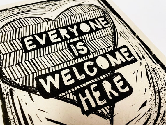 Everyone is welcome here. Community, you are worthy Lino style illusration, block style print, activism, feminism, social justice, heart art
