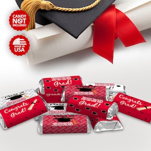 May include: Red and white graduation party favor labels with the text "Class of 2025" and "Congrats Grad!" printed on them. The labels are wrapped around small chocolate bars.