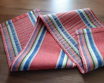 May include: Red, white, blue, and green striped table runner with a woven texture.