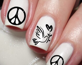 May include: White nail polish with black peace symbols and a dove carrying a sprig. The nails are professionally painted with a glossy finish. The image includes the text "Nailodia" and "Proudly Designed and Produced in Australia."