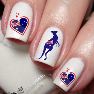 May include: White nail polish with Australian flag designs. The designs include a heart with the flag, a kangaroo with the flag, and a heart with the flag.