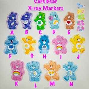 May include: Care Bear X-ray markers in various colors, including blue, green, pink, yellow, and orange. Each marker features a different Care Bear character with unique designs and symbols. The markers are labeled with letters A through N.