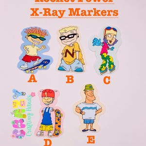 May include: A selection of Rocket Power X-Ray Markers stickers with cartoon characters. The stickers depict characters on skateboards and other designs. The text "Crafting Hands" is also visible on the stickers.