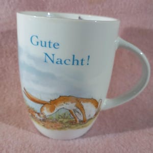 May include: A set of three ceramic mugs with a speckled, matte finish. The mugs are in shades of cream, light gray, and dark gray. Each mug has a simple, minimalist design, perfect for coffee or tea.