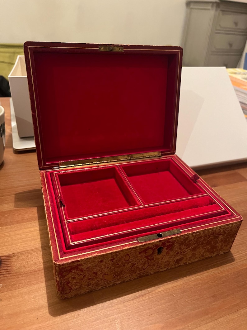 K&ouml;nnte beinhalten: Eine antike Holzk&auml;stchen f&uuml;r Schmuck mit rotem Samt-Innenfutter. Die Box hat einen Klappdeckel und ein Schloss. Das Innere hat zwei F&auml;cher und einen kleinen Ringhalter.